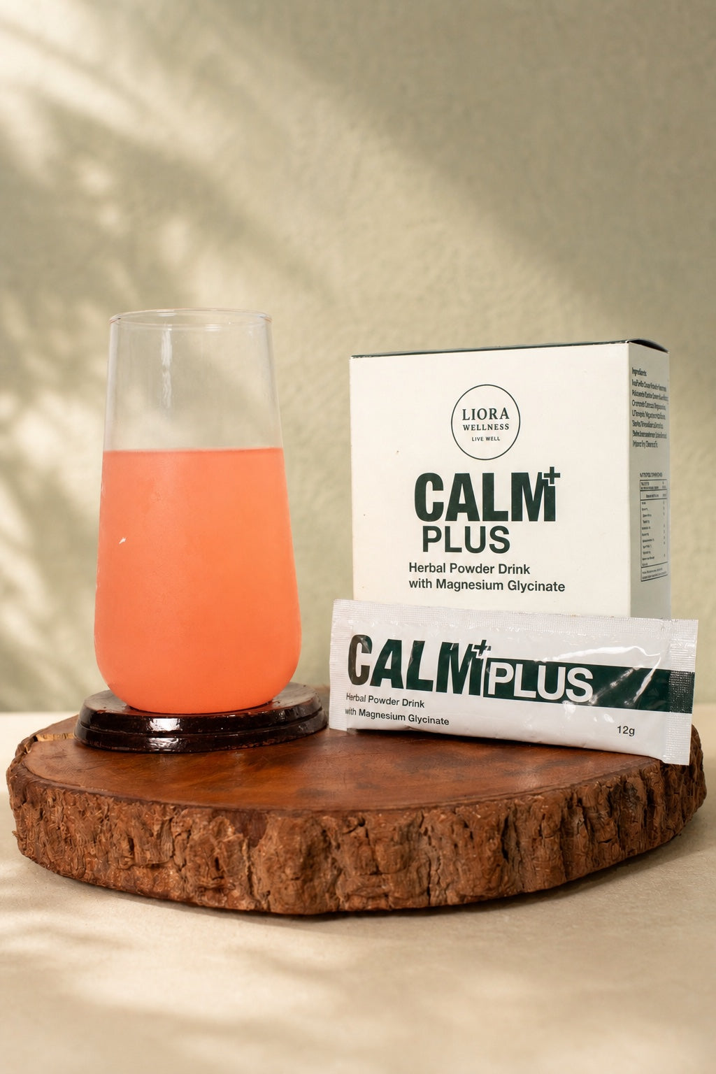 Calm Plus box, sachet and prepared guava drink in a warm, naturally lit recovery setting